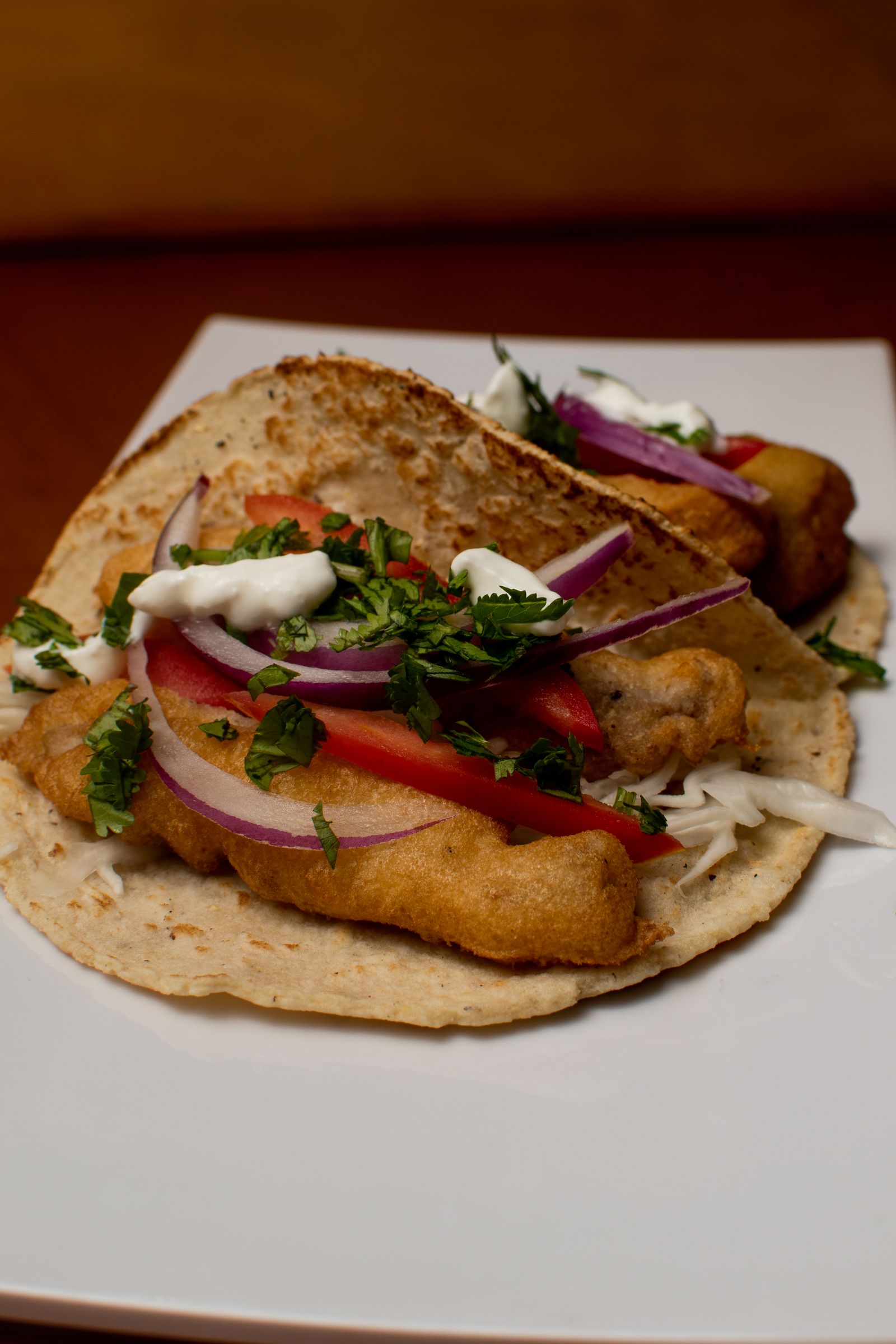 Fish tacos and a drink at a beachside counter
